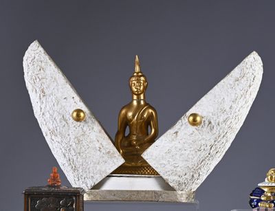 a statue of a buddha sitting on top of a table
