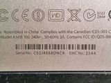 a close up of the back of a silver laptop with a barcode on it