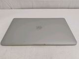 an apple macbook air laptop computer sitting on a white surface