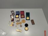 a lot of gold medals and other items on the table