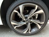 a close up of a tire on a white car