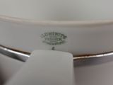 a close up of a white bowl with a handle