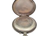 a small silver box with a mirror inside of it