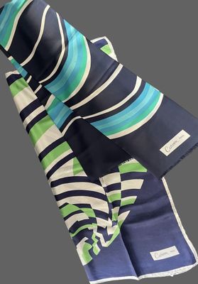 a blue, green and white striped scarf on a gray background