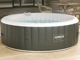 an inflatable hot tub sitting on a patio next to a table and chairs