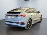 the rear end of a silver audi suv parked in a showroom
