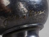 a close up of a vase with a name on it