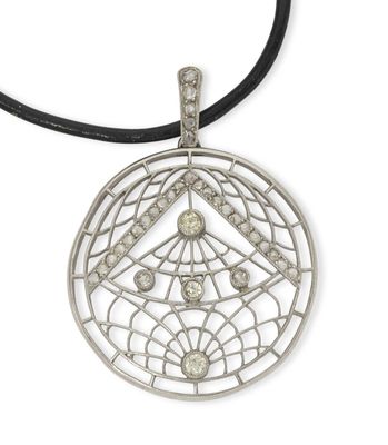 a close up of a silver pendant with diamonds on a black cord