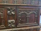 an old wooden cabinet with carvings on the doors