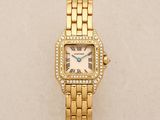 a close up of a gold watch with diamonds on it