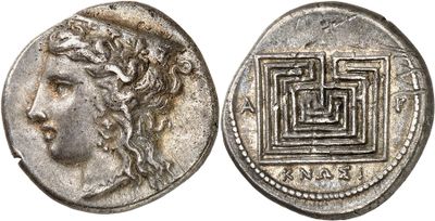 a silver coin with an image of a woman ' s face on it
