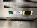 a close up of a metal counter top with a clock on it