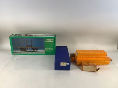 deux boîtes de trains miniatures posées sur une table blanche