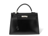 a black leather handbag on a white background