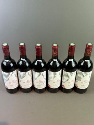 six bottles of red wine lined up in a row on a table