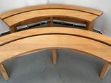 three wooden benches that are sitting in a room