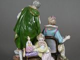 a figurine of a man and a woman sitting at a table