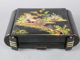 a small black box with a painting on it