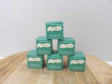 several boxes of soap sitting on top of a wooden table