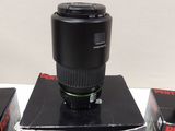 three camera lenses sitting on top of a box on a table