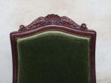 a chair with a green velvet upholstered on it