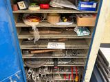 a blue cabinet filled with tools and other items