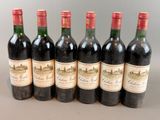 six bottles of wine are lined up in a row on a table