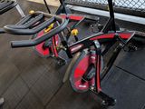 several exercise bikes are lined up in a row in a gym