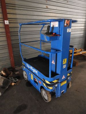 the blue scissor is parked in front of a garage door
