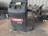 a trash can sitting next to a trash can in a garage