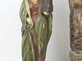 a statue of a woman holding a lantern next to a statue of a man