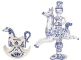 two blue and white figurines of a man riding a horse and a rocking horse