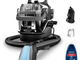 the black and silver vacuum is next to a bottle of cleaner