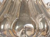 a silver vase that is sitting on a table