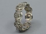a close up of a silver ring on a gray surface