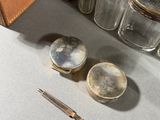 a brown case and a pair of scissors on a table