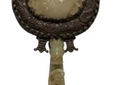 a picture of a mirror with a carved handle