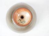 a brown and white vase with writing on it