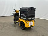 a yellow motorcycle with a black box on the back of it