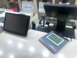 a monitor and a tablet on a desk in a room