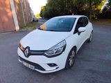a white car parked on the side of the road in front of a building