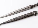 pair of antique knifes on a white surface with a white background