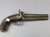 an old gun that is sitting on top of a table