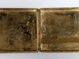 an image of a gold case with a gold ribbon on it
