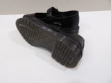 a pair of black shoes that are on a table