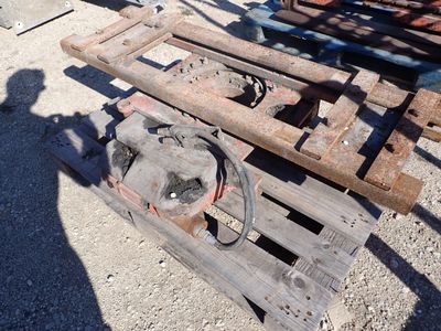 a wooden pallet sitting on the ground next to a pile of wood