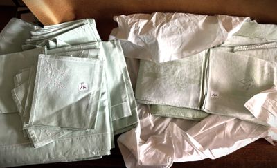 a pile of folded towels and napkins on a table