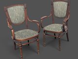 une paire de chaises anciennes dont les assises sont recouvertes d'un tissu à motif zébré