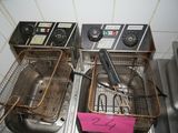 two deep fryers that are sitting on a counter