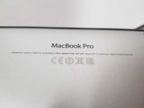 the back of a macbook pro laptop with the logo on it